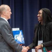 Dean Potteiger shaking hands with a student winner